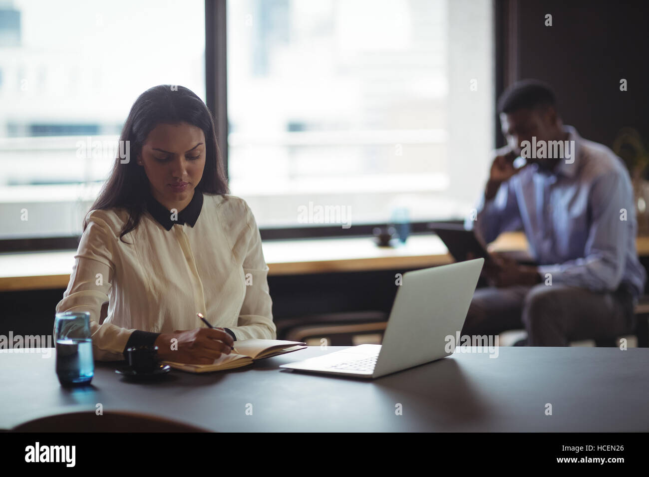 Businesswoman working at her desk Stock Photo