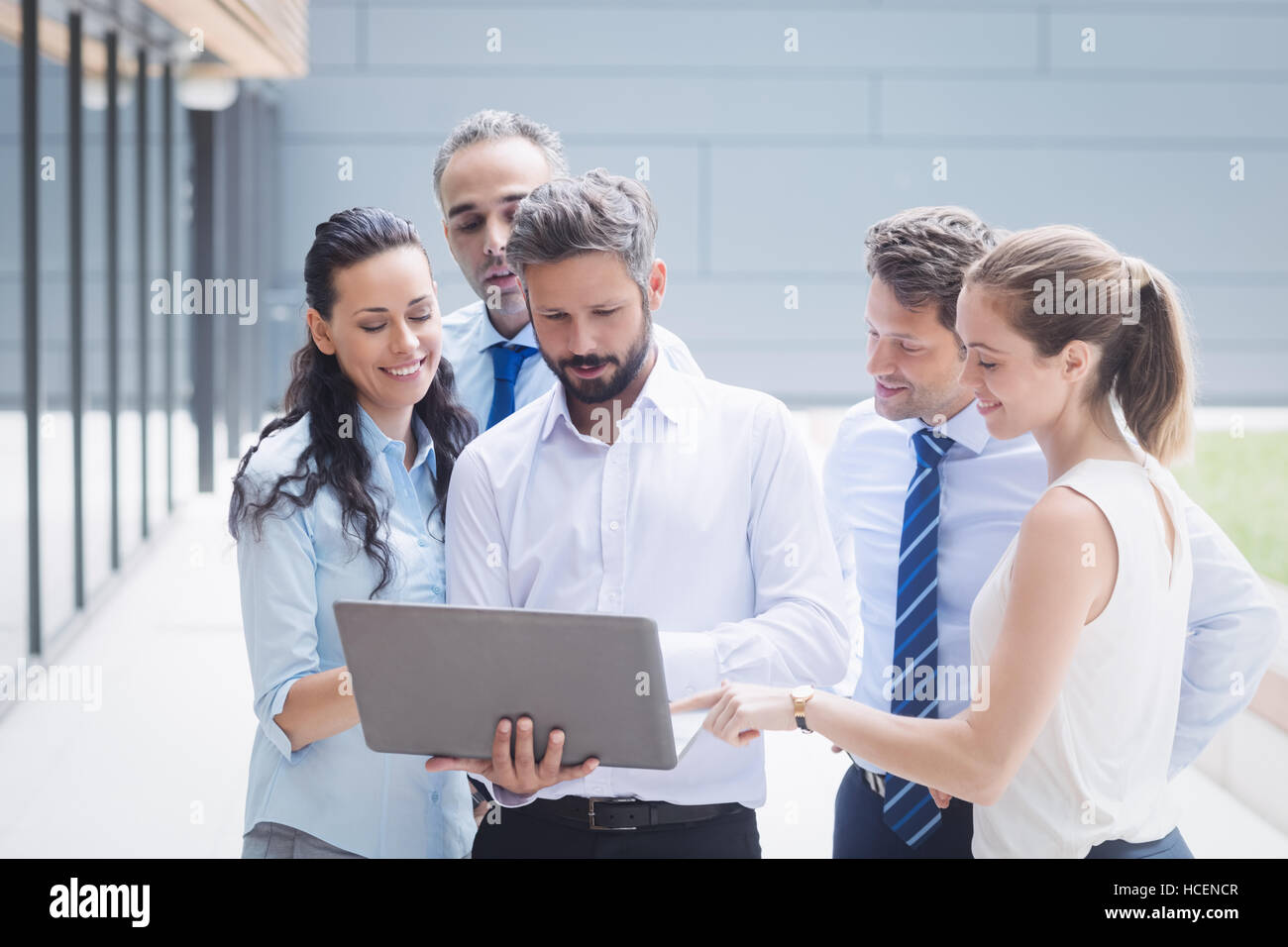 Businesspeople discussing over laptop Stock Photo