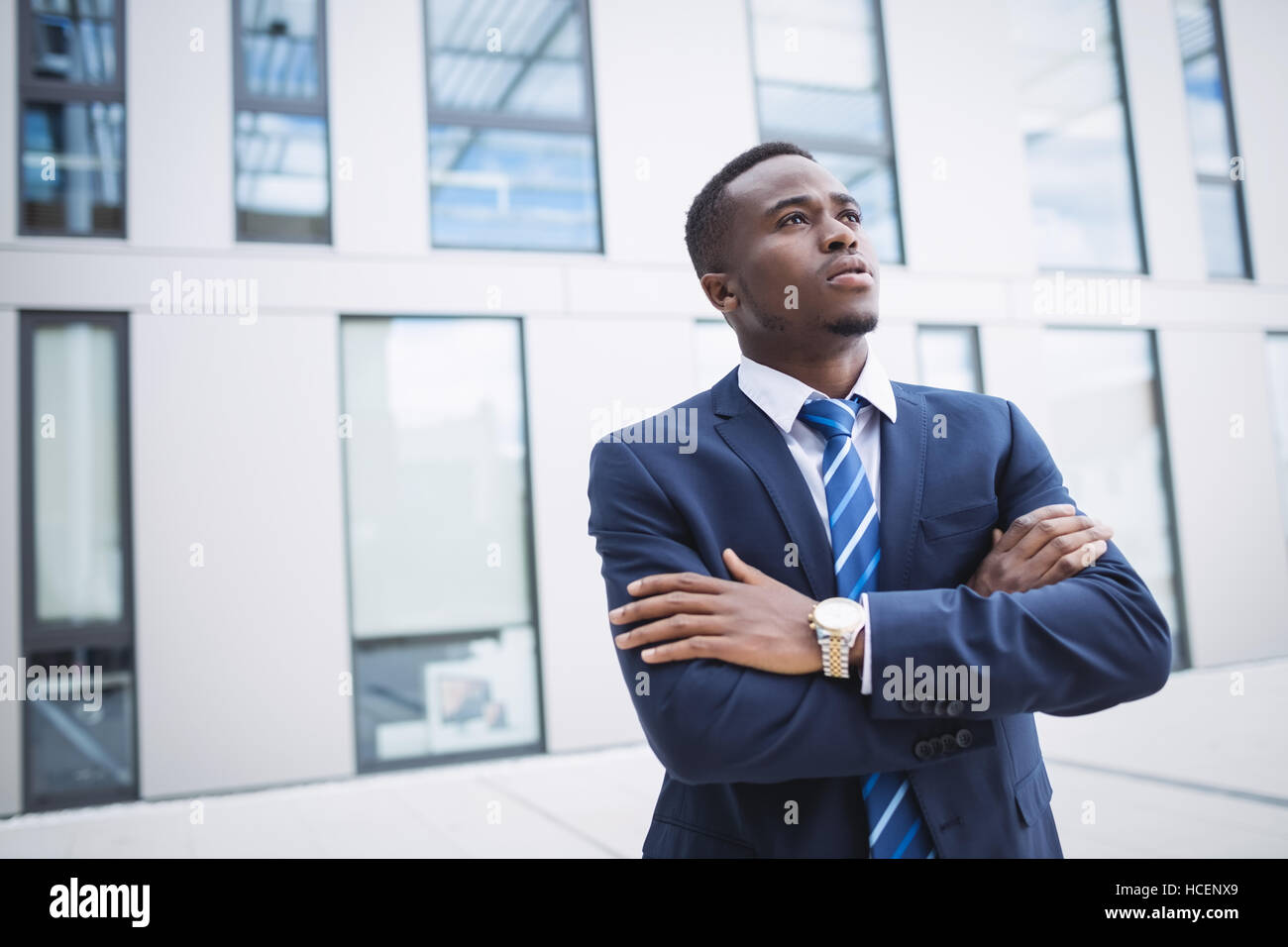 Businessman standing outside office building Stock Photo