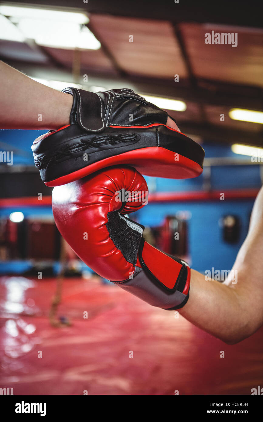 Female boxer practicing with trainer Stock Photo