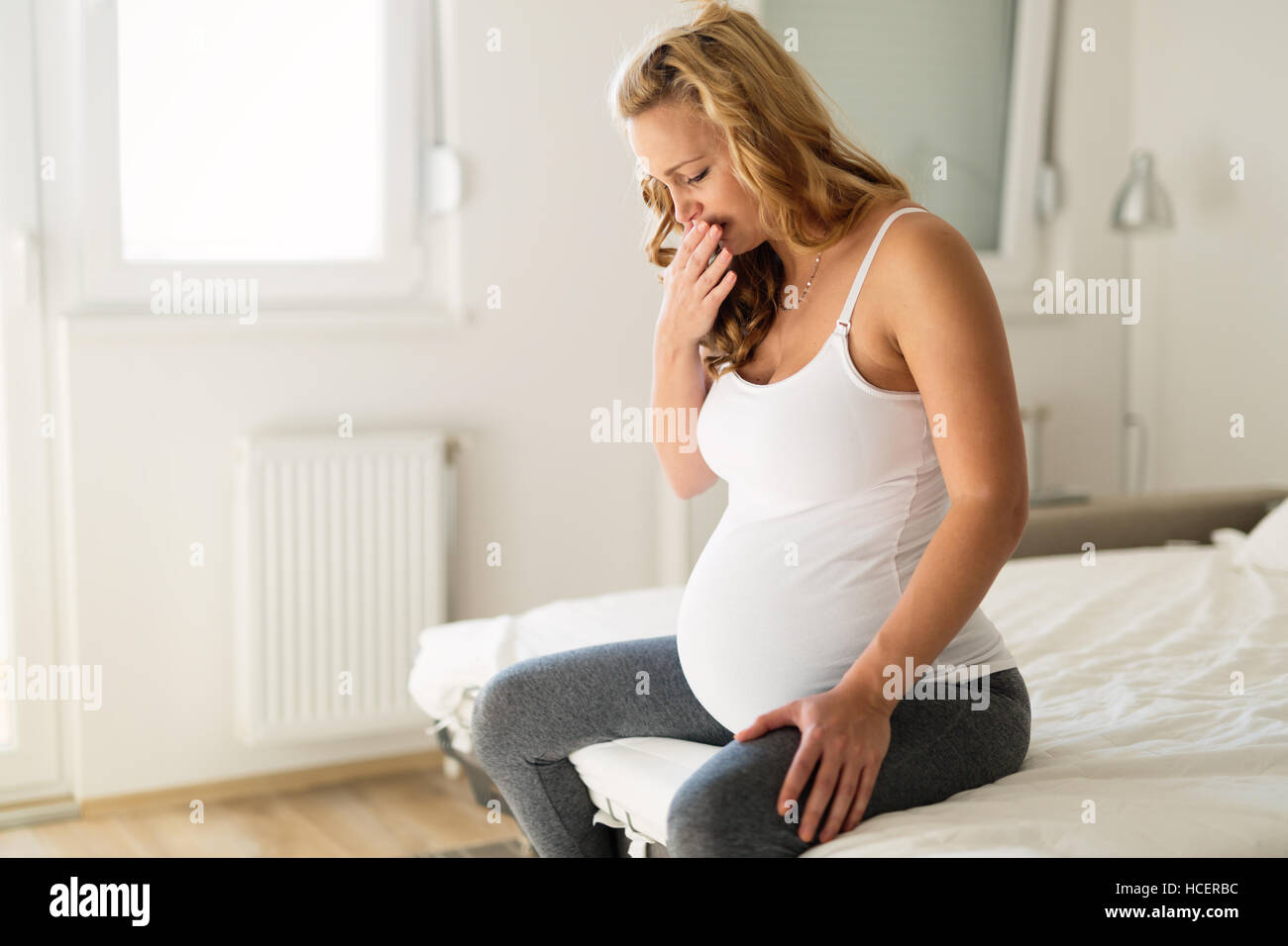 Pregnant woman suffering with nausea in morning Stock Photo