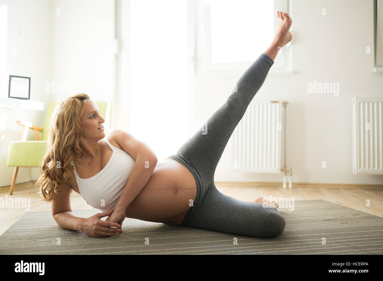 Pregnant woman staying active and healthy at home Stock Photo