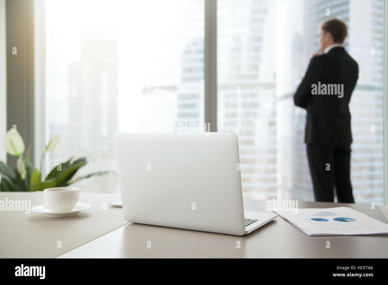 Confident business man contemplating in his office Stock Photo