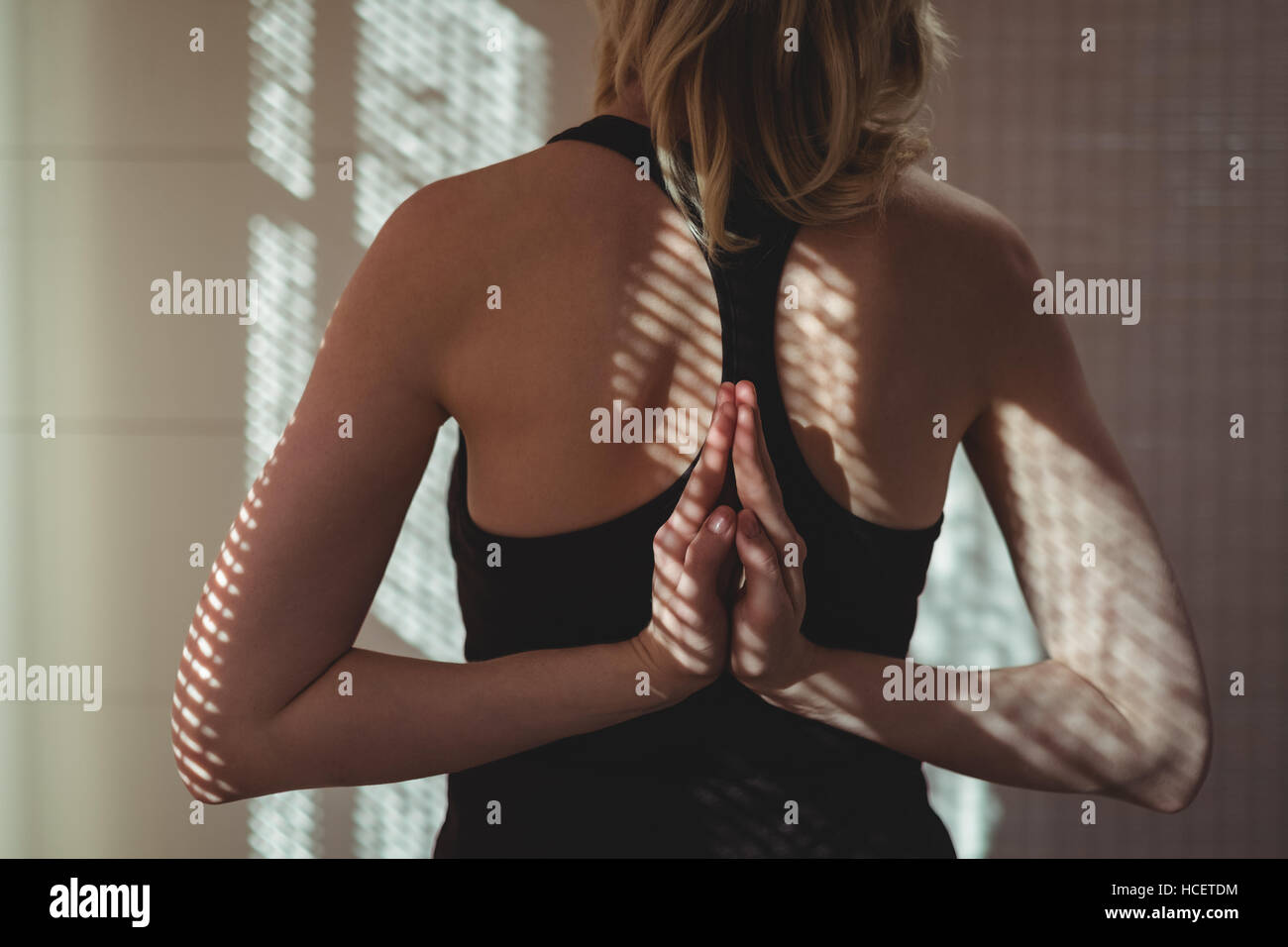 Rear view of woman practicing yoga Stock Photo