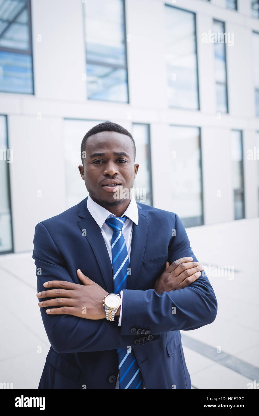 Businessman standing outside office building Stock Photo - Alamy