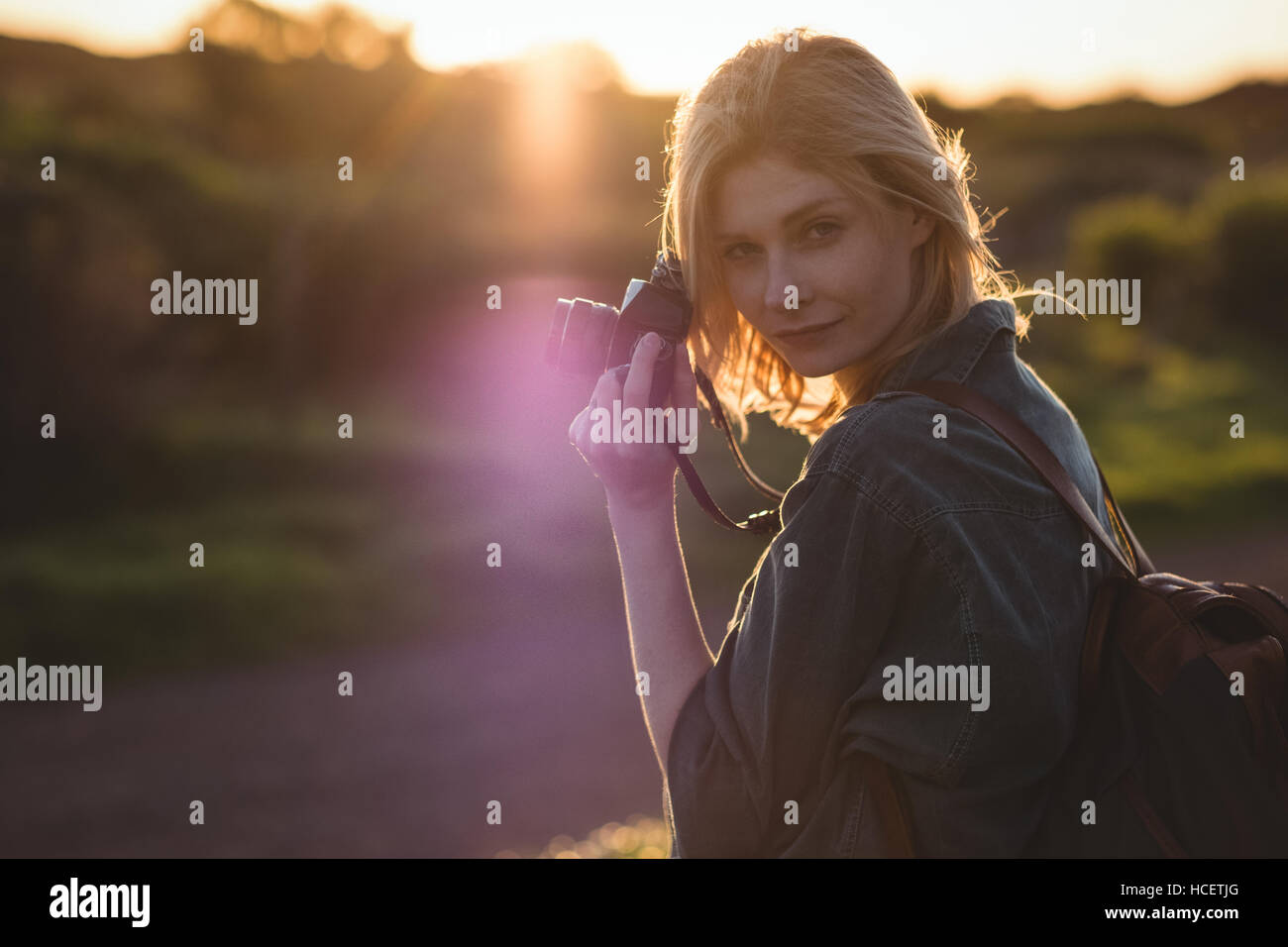 Beautiful woman holding digital camera Stock Photo