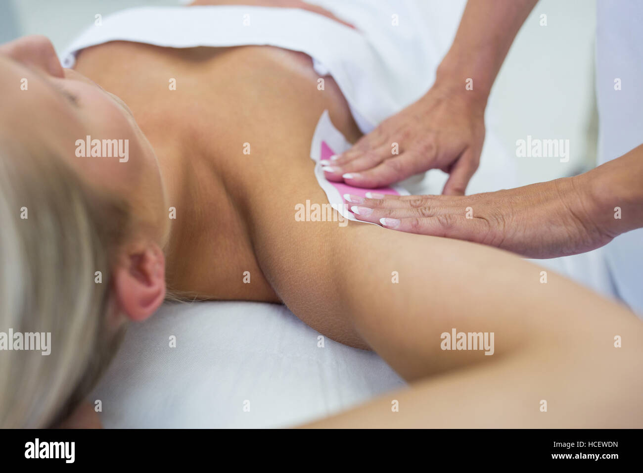 Woman getting her armpit hair removed Stock Photo