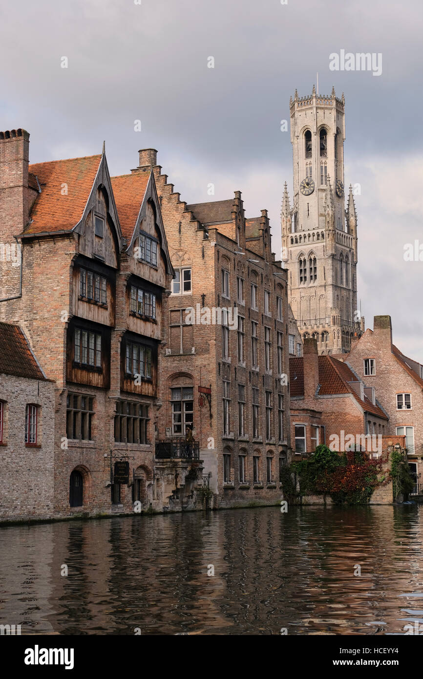 Canalside buildings of Bruges, Belgium. In the background is the Belfort belfry tower. Stock Photo