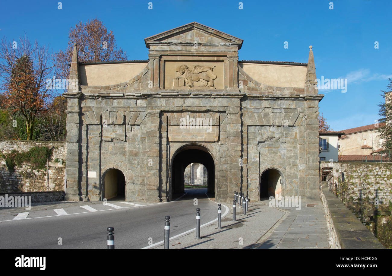 Bergamo, Italy. Gate to the Citta Alta, seen from Viale Vittorio Emmanuele. Obelisks on the corners, and plaque with the winged lion of St Mark Stock Photo