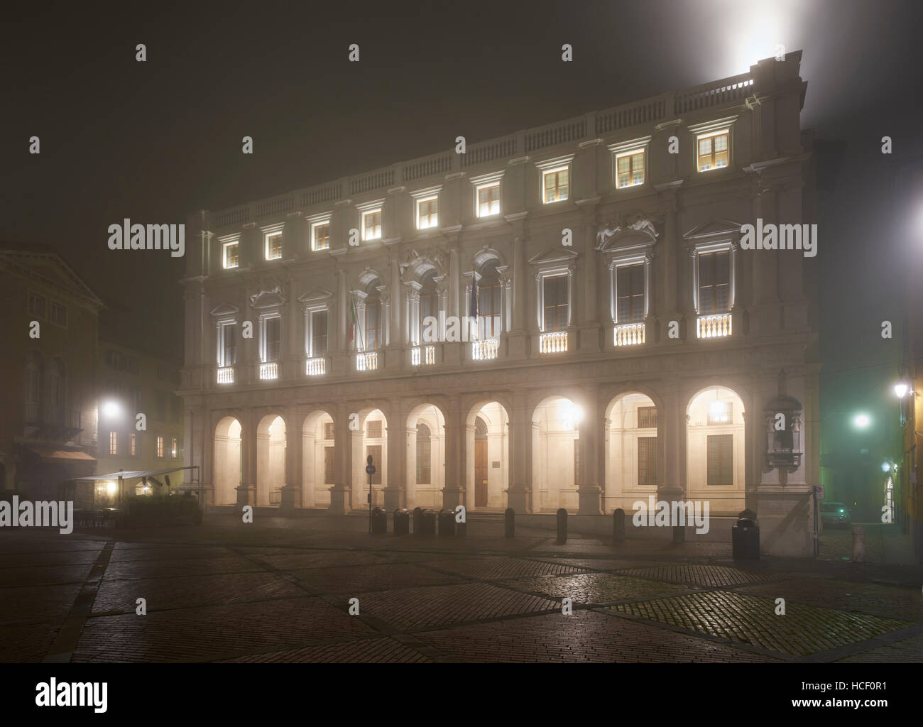 Bergamo, Italy. Palazzo Nuovo (now the Biblioteca Civica Angelo Mai) on Piazza Nuova, night shot taken in foggy conditions. Stock Photo