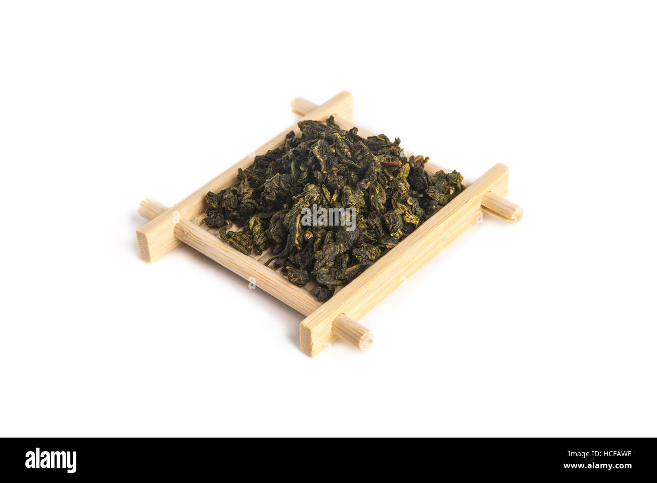 Bamboo serving tray with Tie Guan Yin Oolong tea, isolated on white background Stock Photo