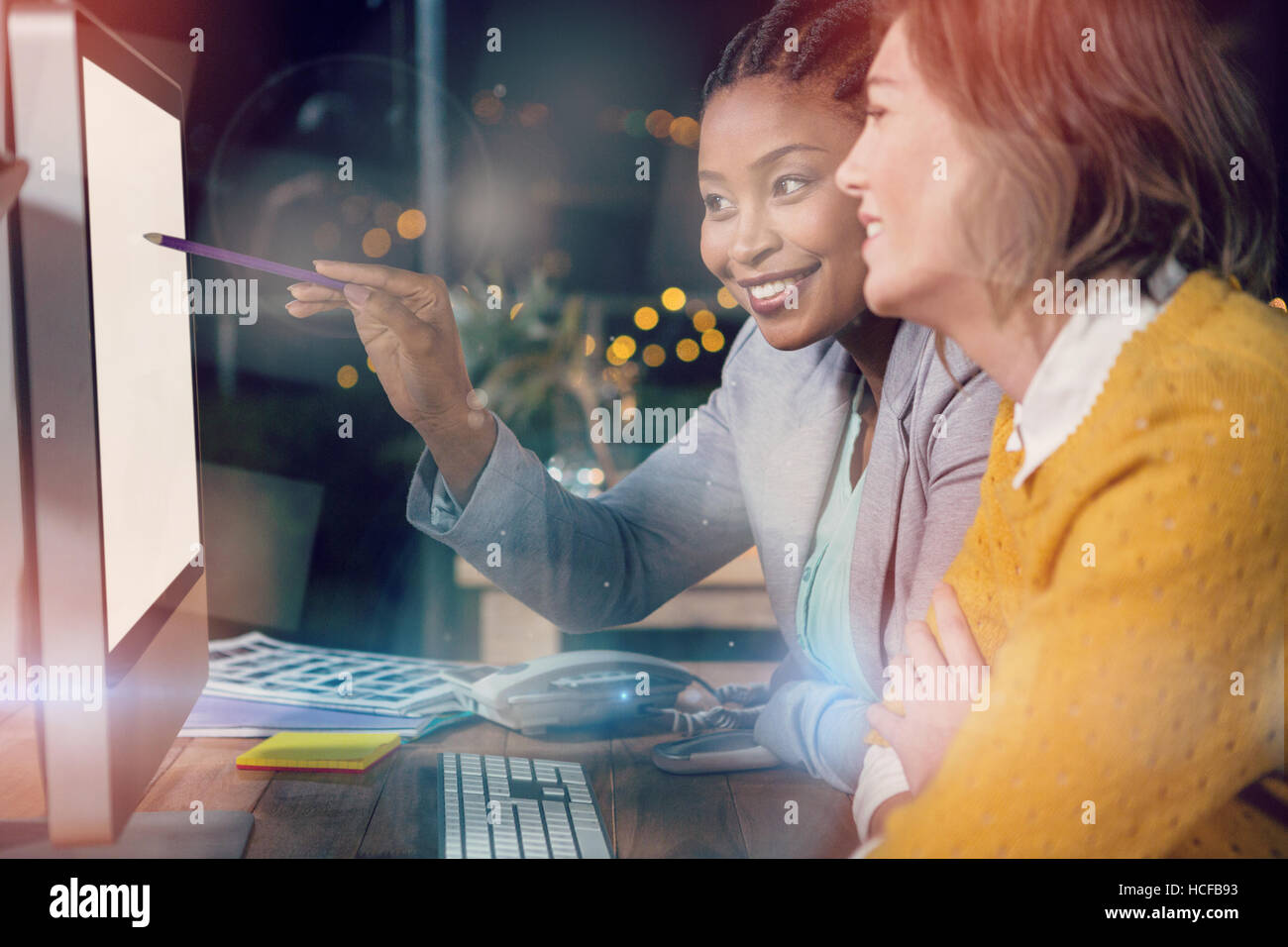 Businesswomen working on computer at desk Stock Photo - Alamy