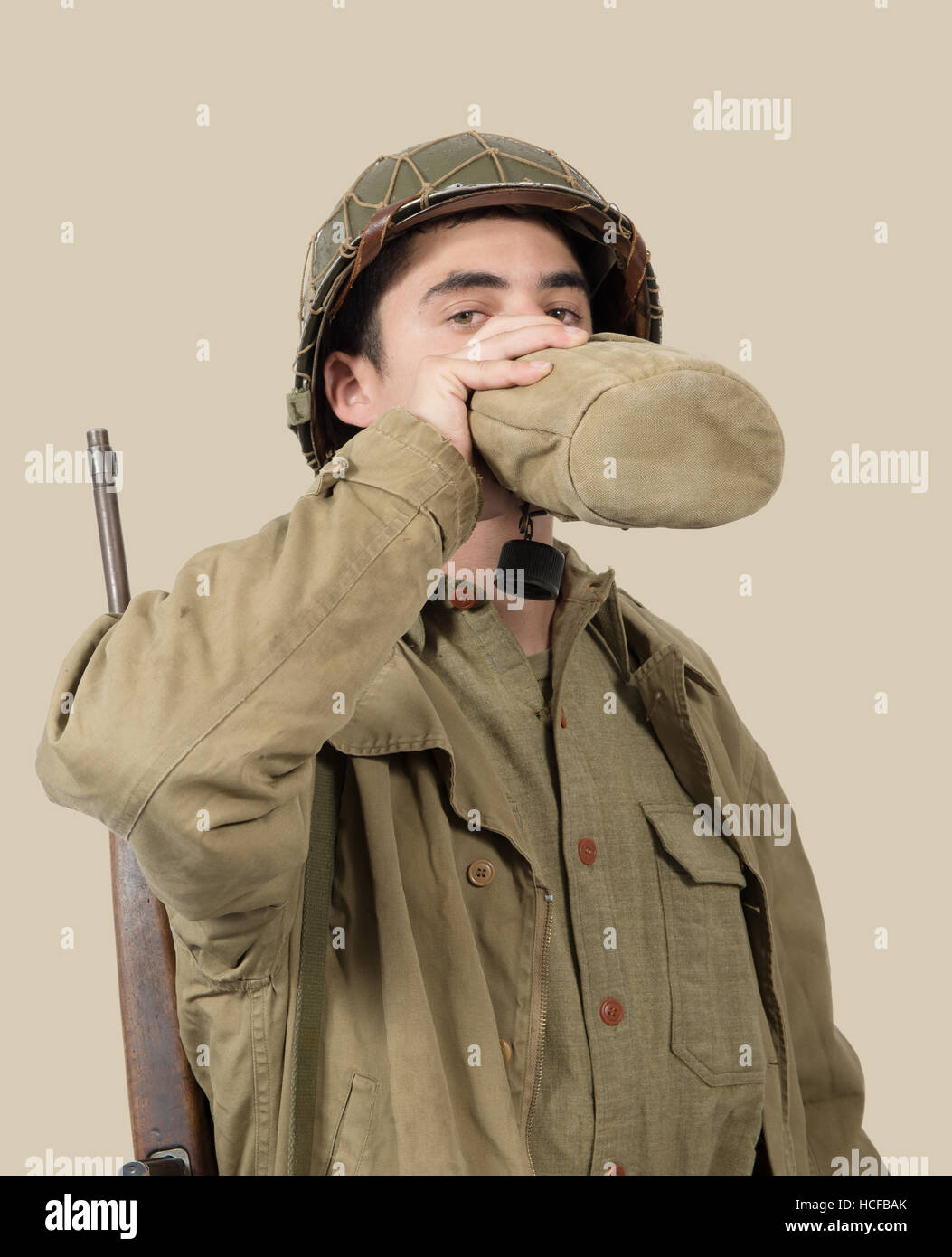 Young American Soldier Drink Water In His Can World War Two Stock young-american-soldier-drink-water-in-his-can-world-war-two-stock