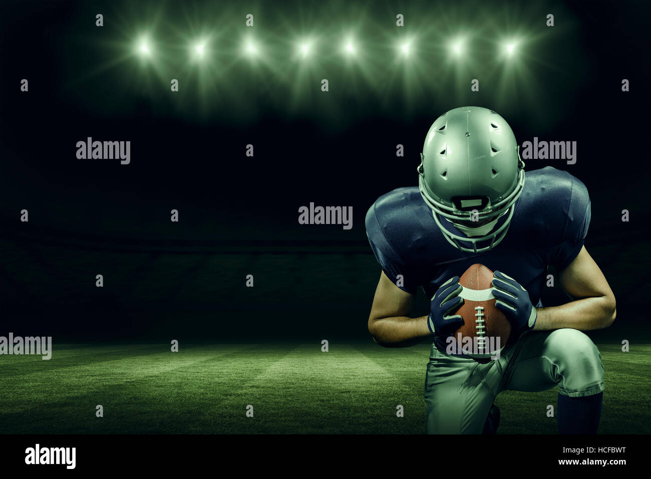 Composite image of american football player kneeling Stock Photo Alamy