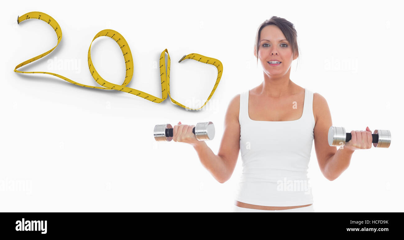 Composite image of portrait of young woman exercising with dumbbells Stock Photo