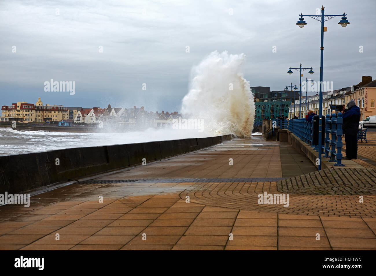 Waves crashing over sea wall Porthcawl, Wales, UK Stock Photo