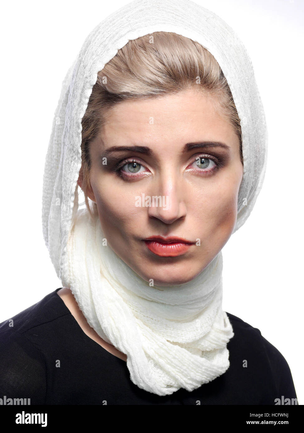 A head and shoulder portrait of a blond haired woman wearing a white scarf. Stock Photo