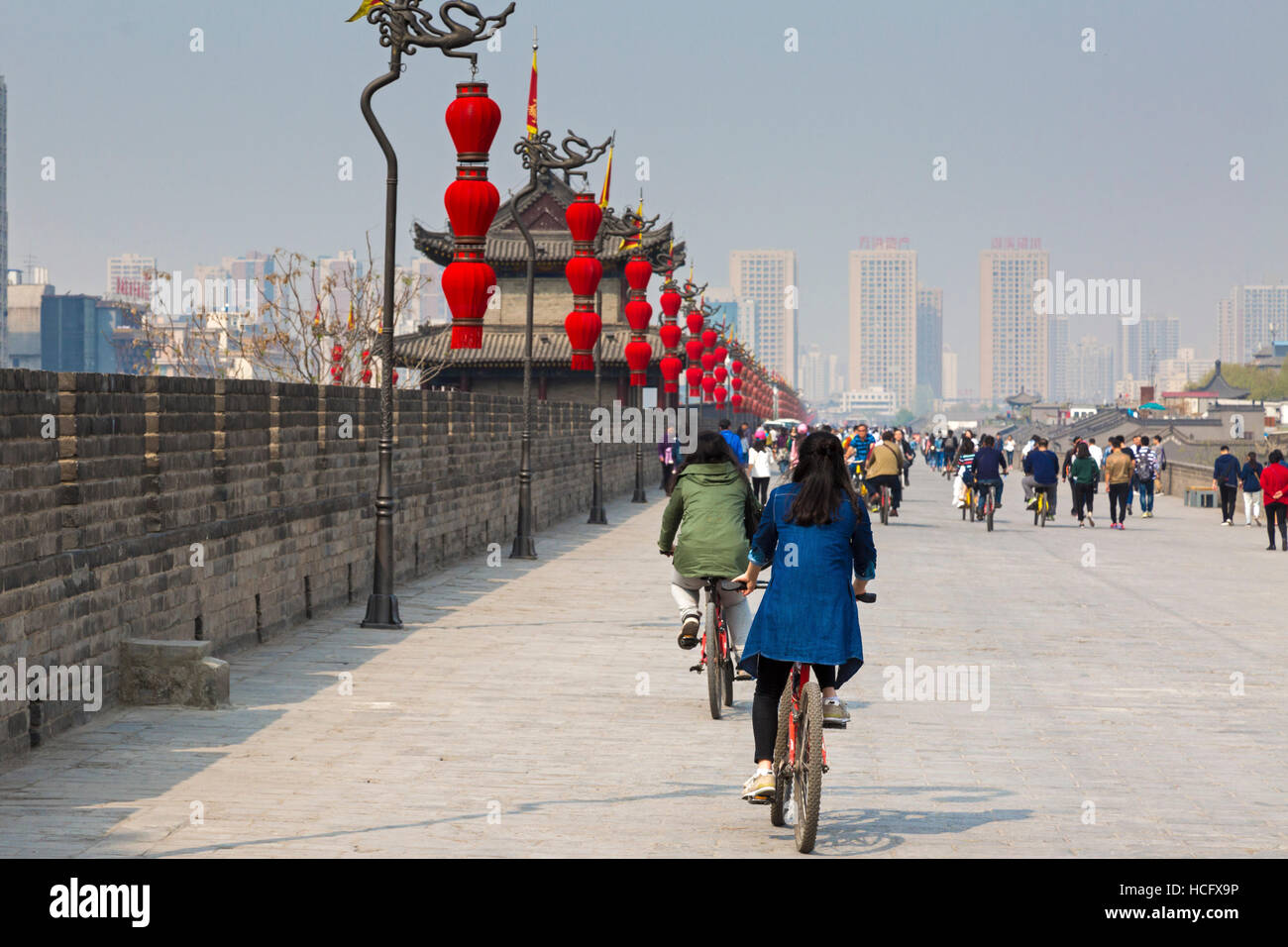 Tourists walking and cycling on Xian city walls, Shaanxi, China Stock Photo