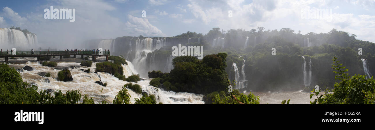 Iguazu: people on the walkway and panoramic view of the spectacular Iguazu Falls, one of the most important tourist attractions of Latin America Stock Photo