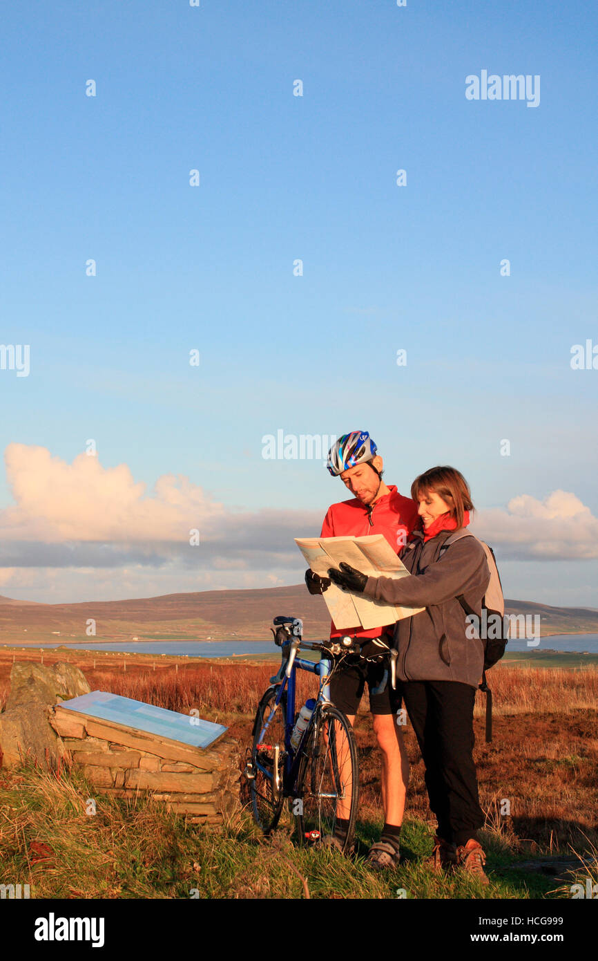 Hiker giving a cyclist directions Stock Photo