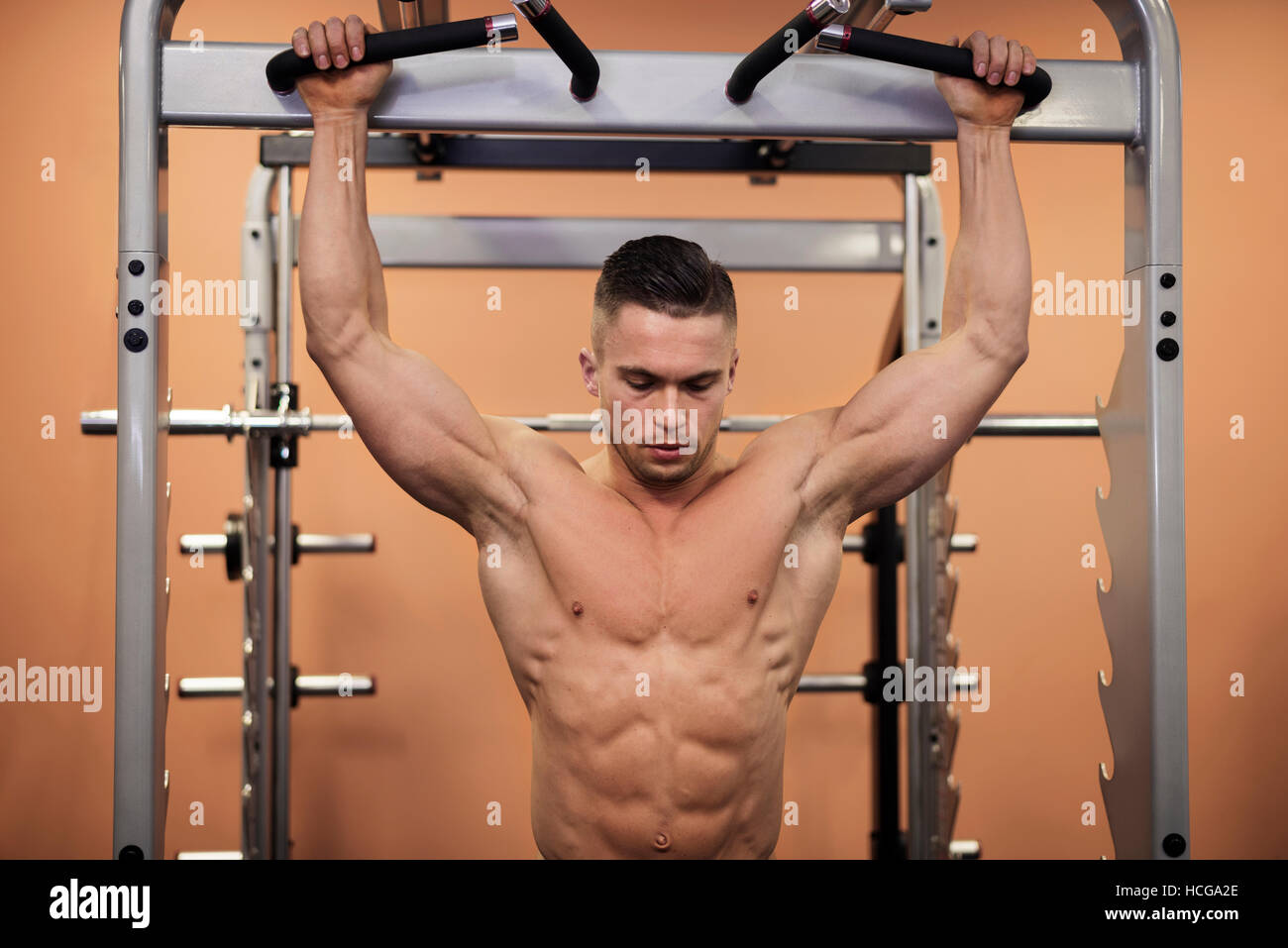 Handsome muscular man shirtless pulling down underwear, on grey background  Stock Photo - Alamy