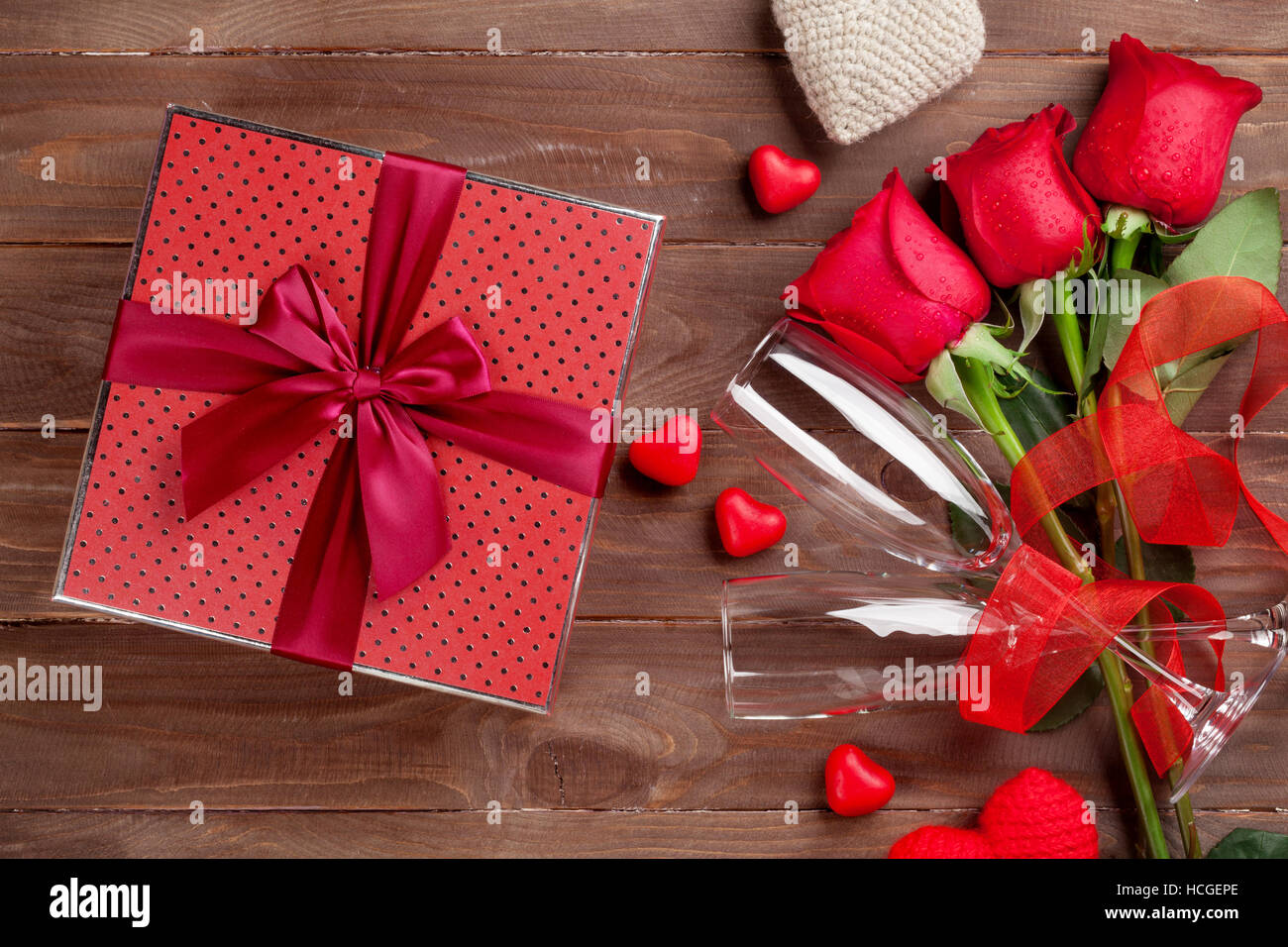 Valentines day gift box with hearts, red roses and champagne glasses on ...