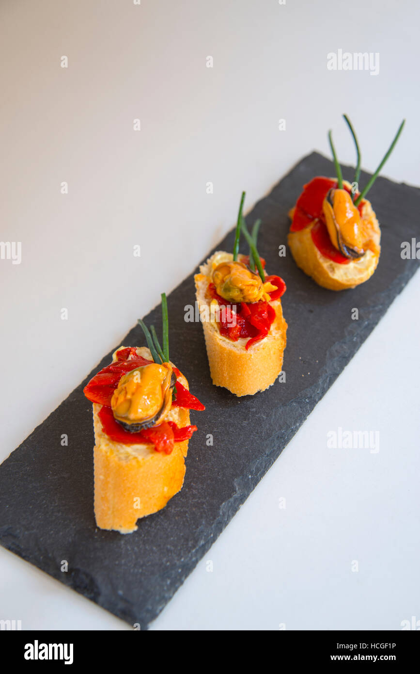 Spanish tapas mussel with red pepper on toast Stock Photo Alamy