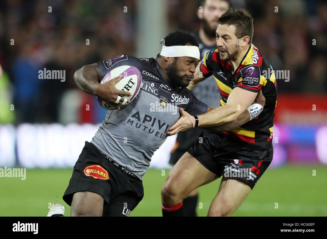 Stade Rochelais' Levani Botia hands off Gloucester's Greig Laidlaw during the Challenge Cup match at Kingsholm Stadium, Gloucester. Stock Photo