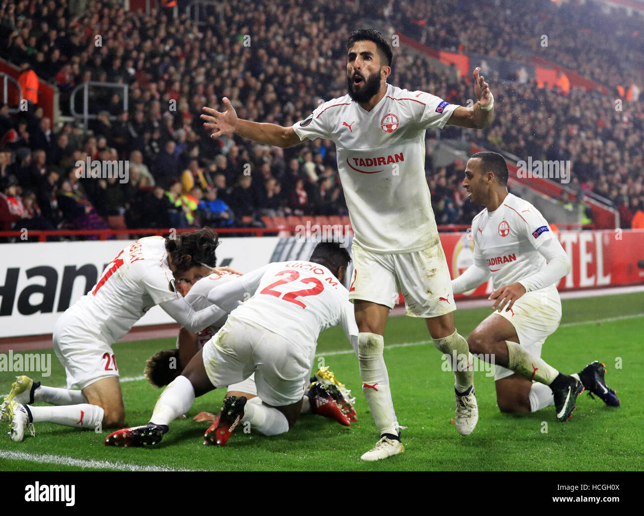 Hapoel Be'er Sheva's Maor Bar Buzaglo (hidden) celebrates scoring his side's first goal of the game with team-mates during the UEFA Europa League, Group K match at St Mary's Stadium, Southampton. Stock Photo