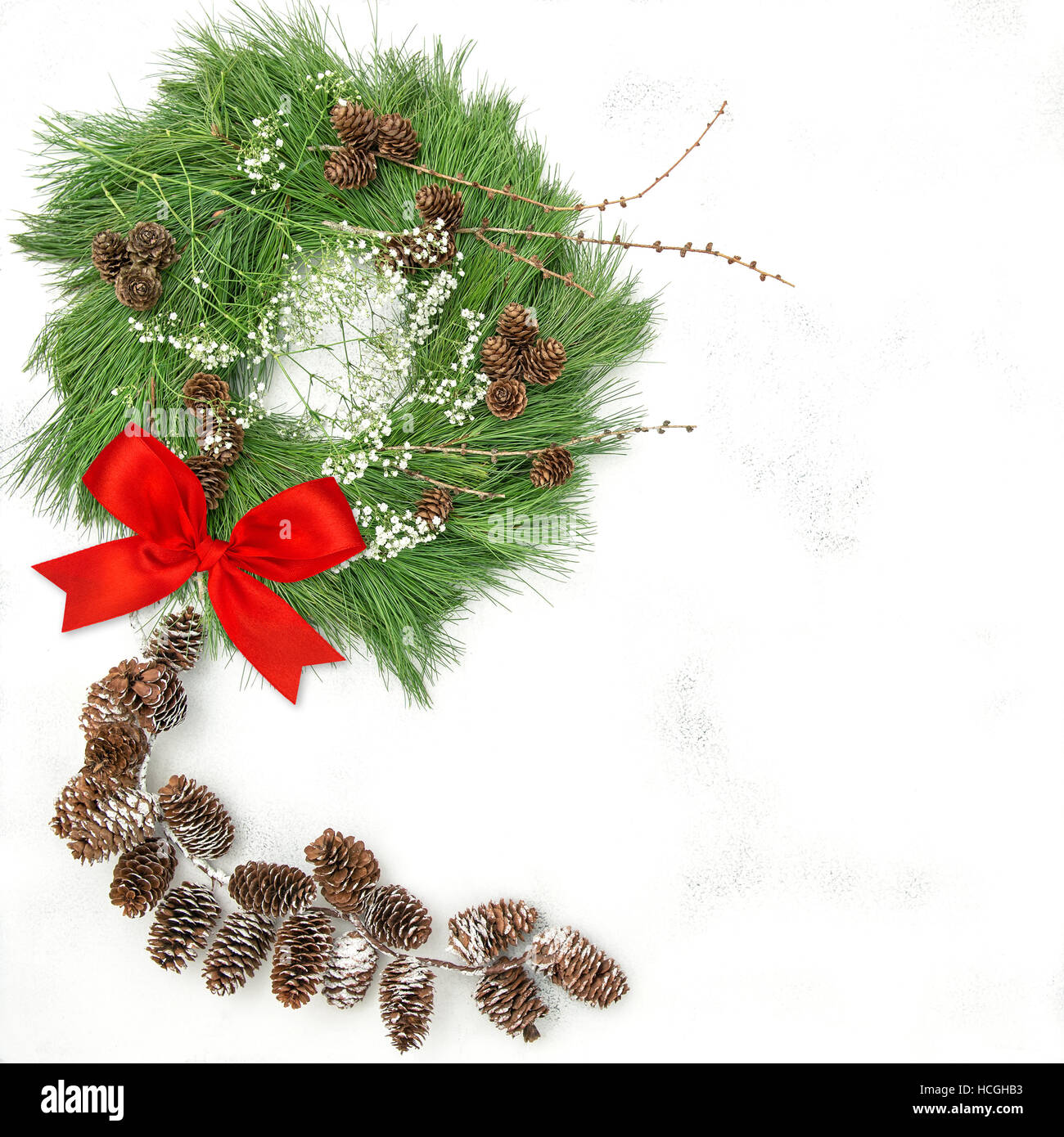 Christmas wreath with pine cones garland and red ribbon bow Stock Photo ...
