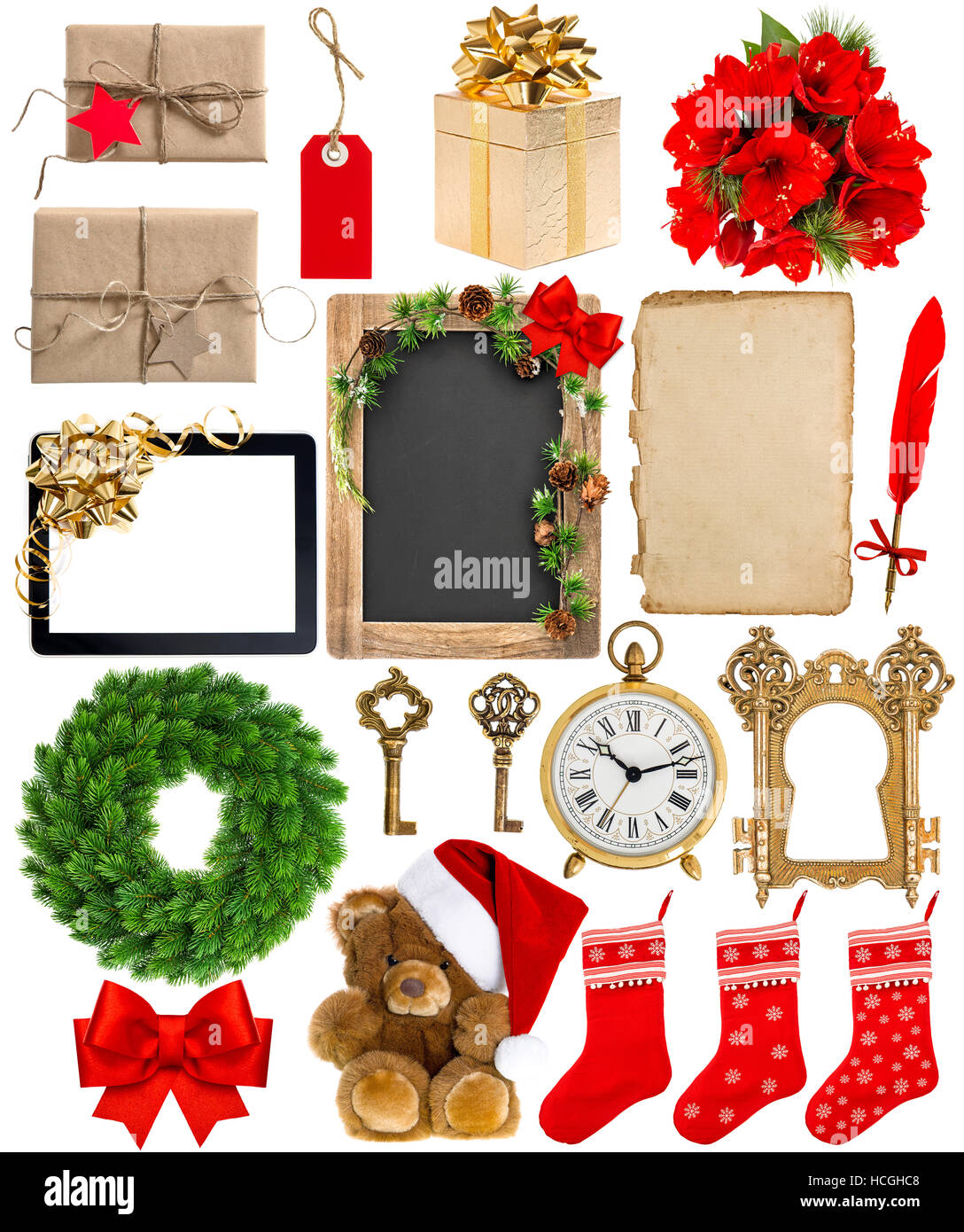 Christmas decoration, ornaments and gifts. Old book page, paper, wreath, blackboard, flowers, wrapped gifts isolated on white background Stock Photo