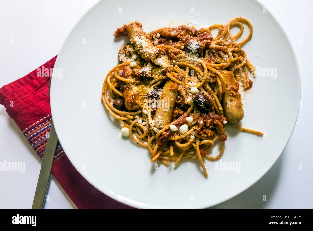 Spaghetti with sausage and olives Stock Photo