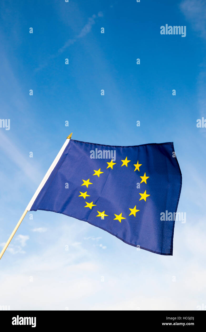 European Union flag flying in front of bright blue sky Stock Photo