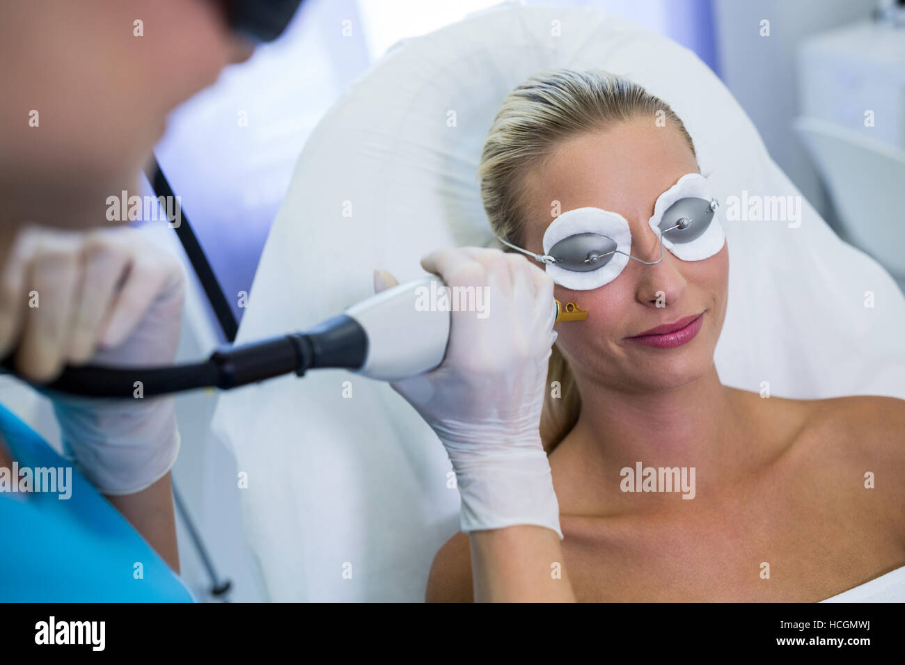Woman receiving laser epilation treatment on her face Stock Photo