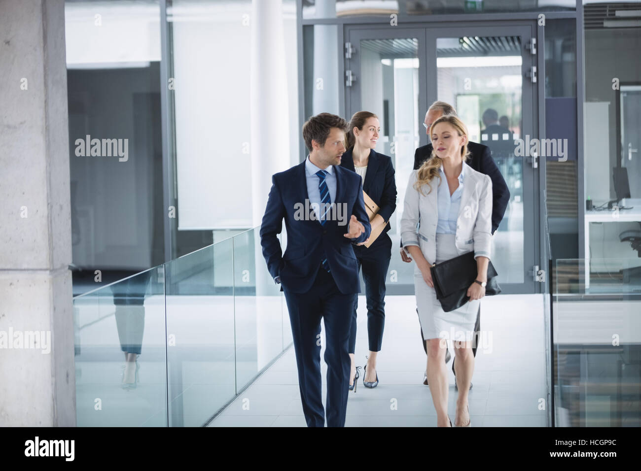 Businessman walking with colleagues Stock Photo