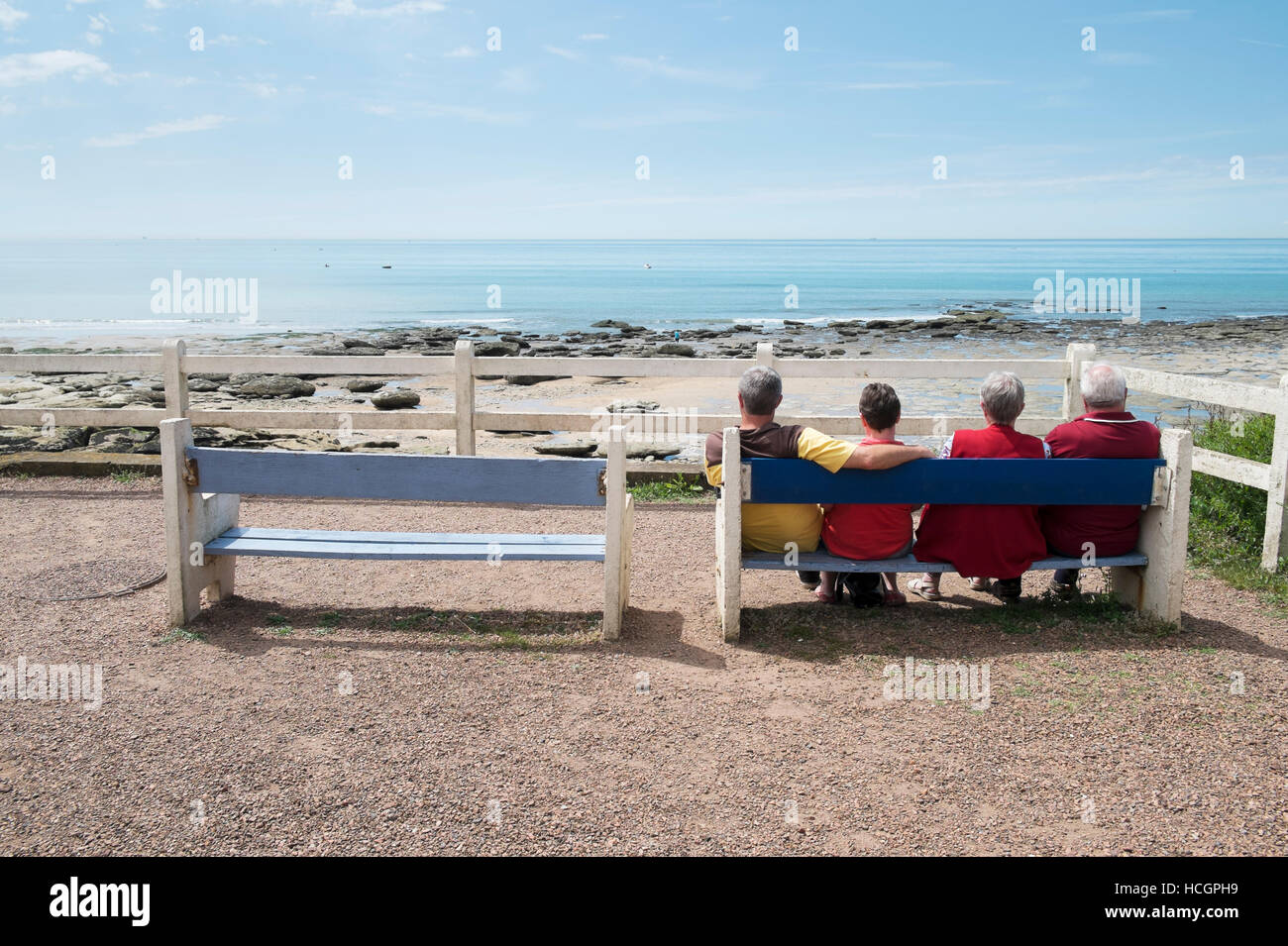 four people looking to england coastline Stock Photo