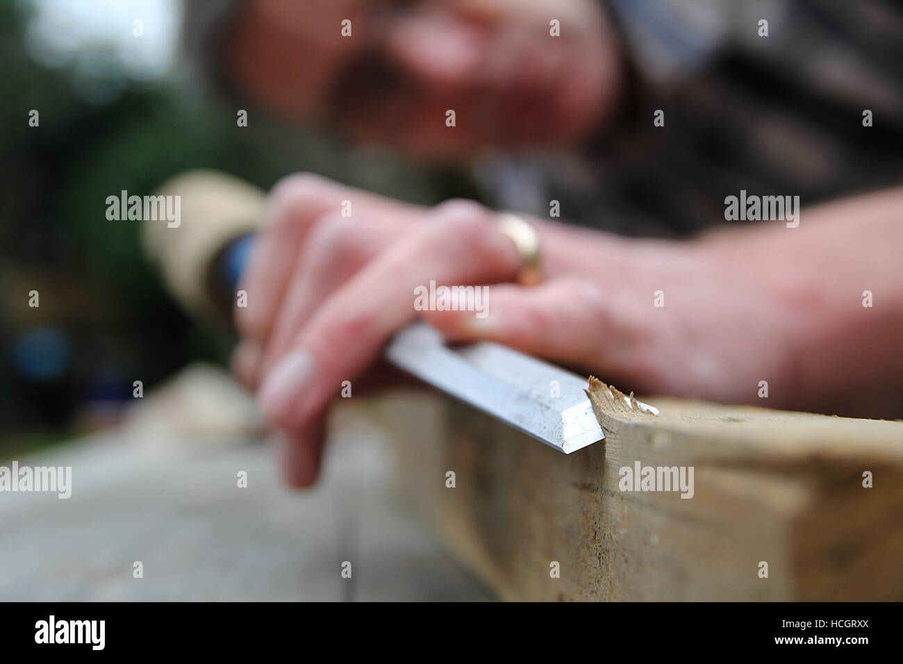Traditional woodworker using wooden mallet and chisel Stock Photo