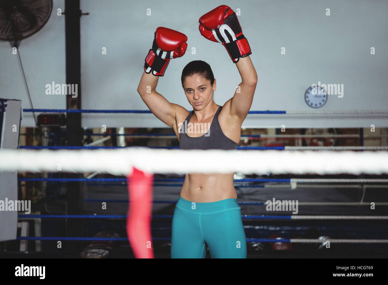 Excited female boxer posing after victory Stock Photo