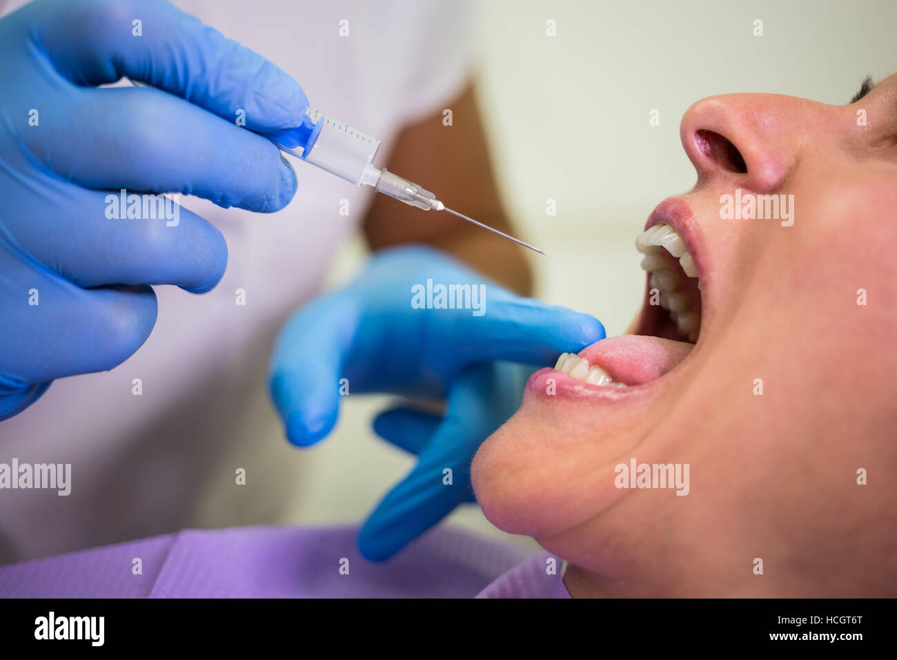 Dentist giving injection to the female patient Stock Photo Alamy