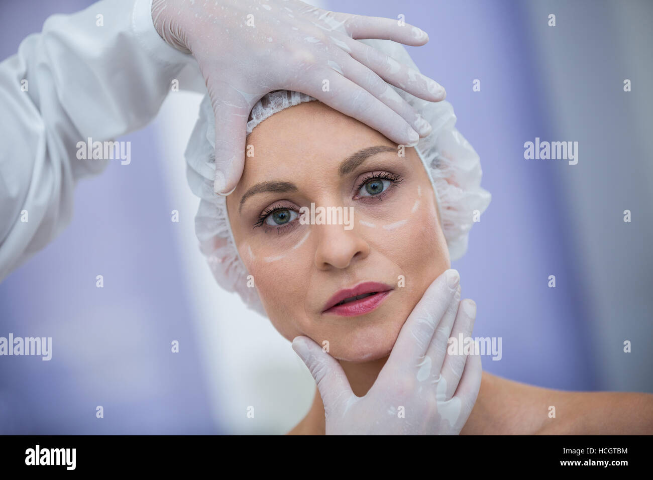 Doctor examining female patients face for cosmetic treatment Stock Photo