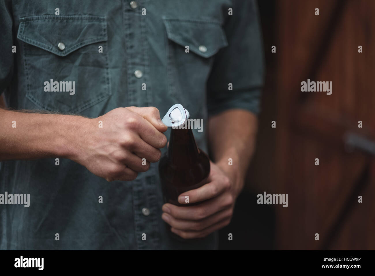 Man opening a beer bottle Stock Photo