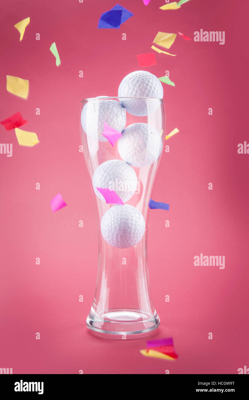 Golf balls in a glass with confetti Stock Photo Alamy