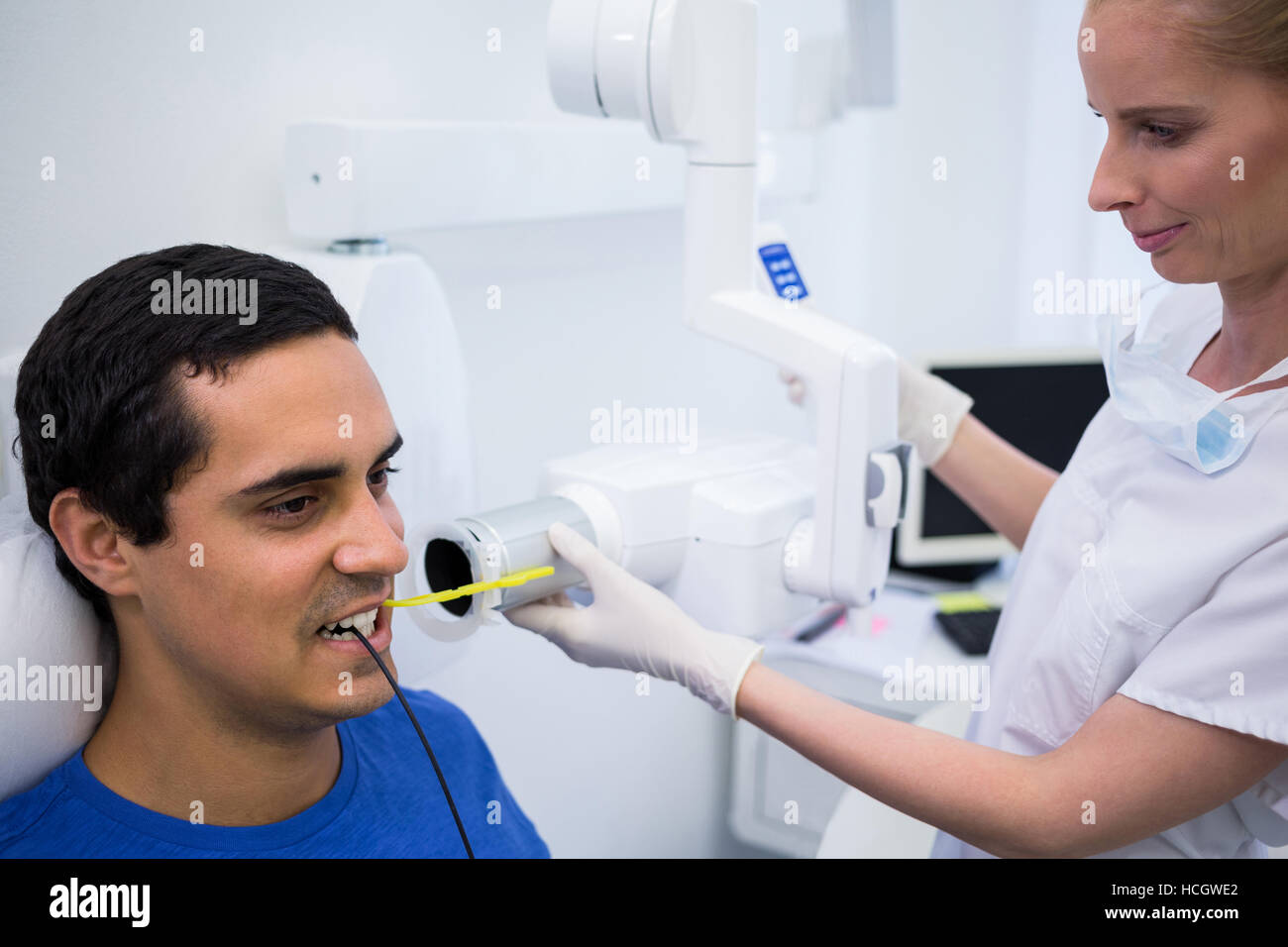 Dentist taking a male patients tooth xray Stock Photo Alamy