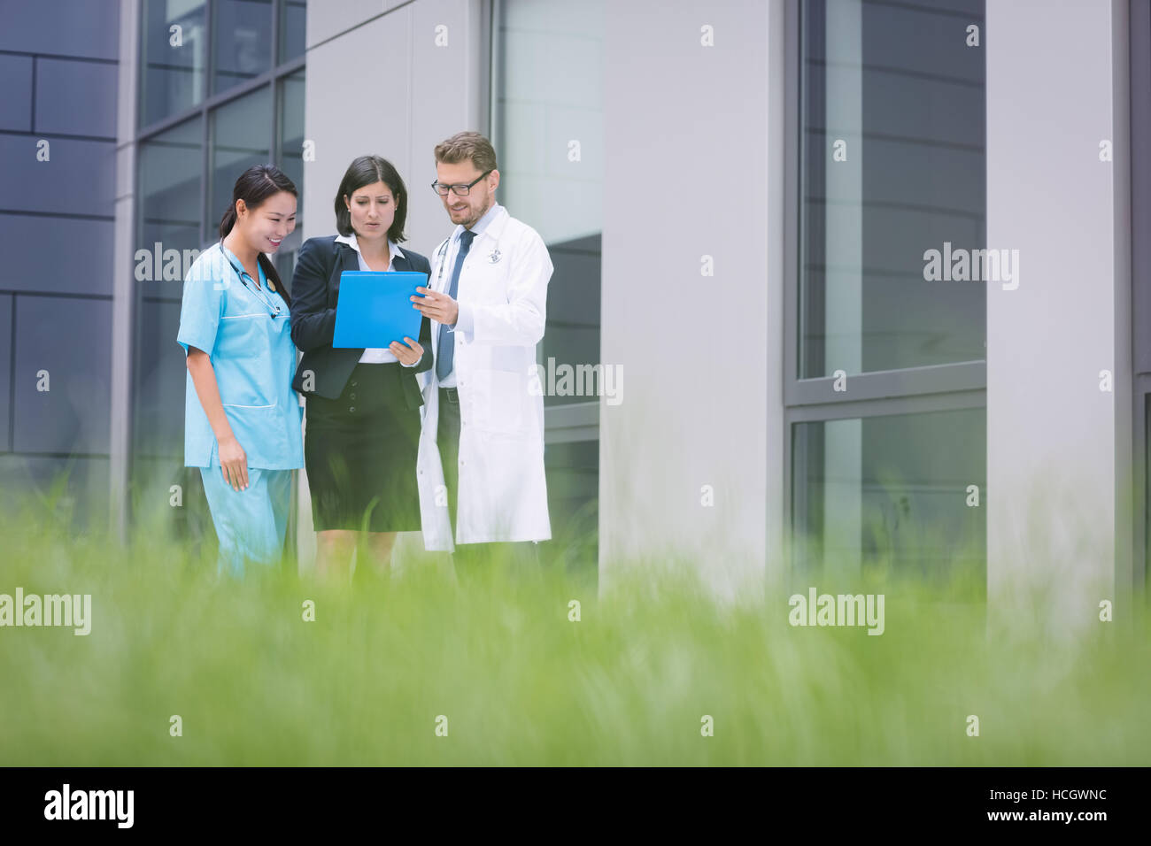 Doctors and nurse discussing over report Stock Photo