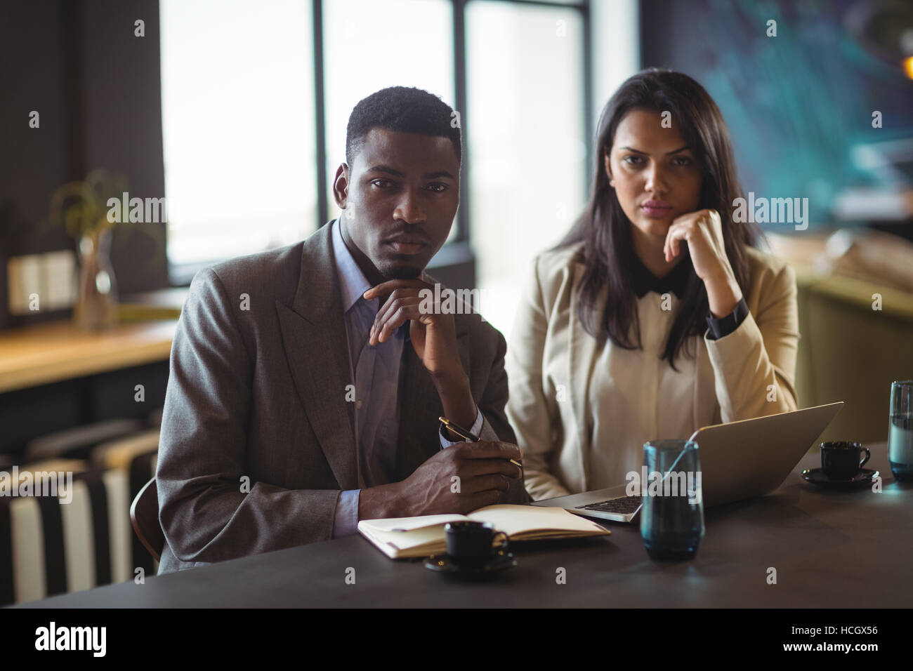Businessman and a colleague at desk Stock Photo