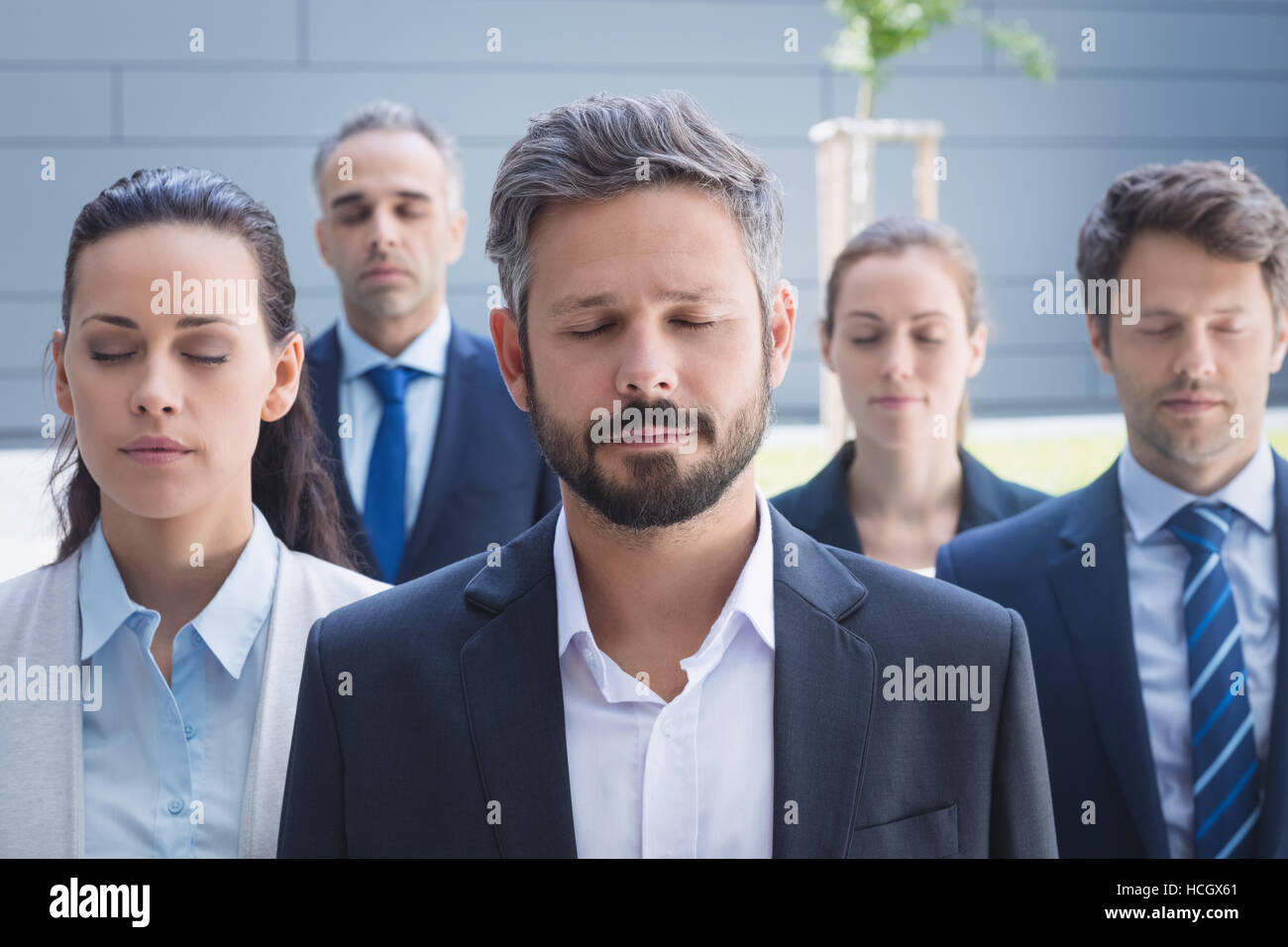 Group of business people with eyes closed Stock Photo