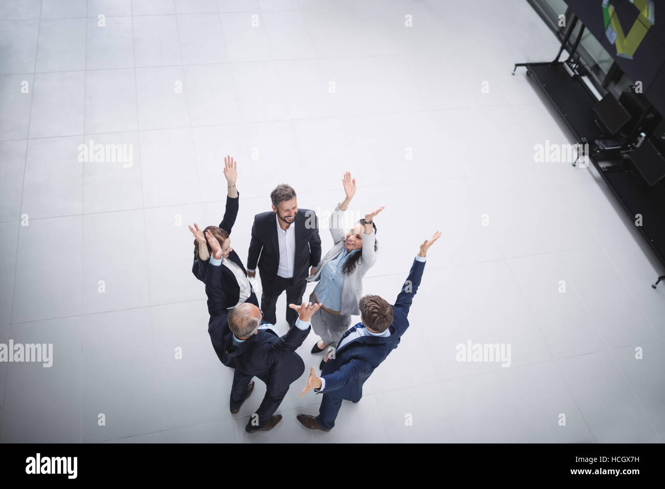 Businesspeople standing with hands raised Stock Photo