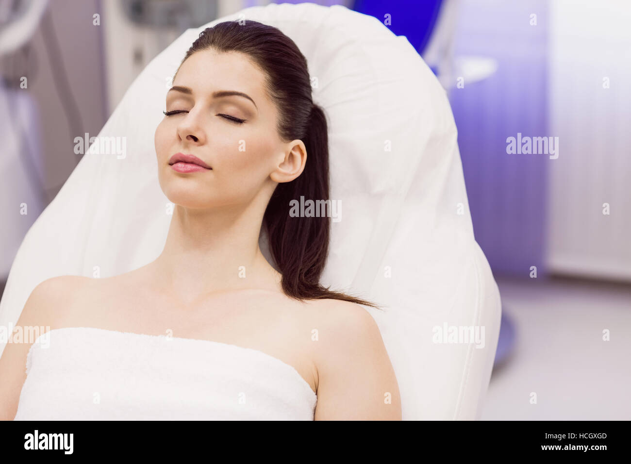 Female patient lying on dermatology chair Stock Photo