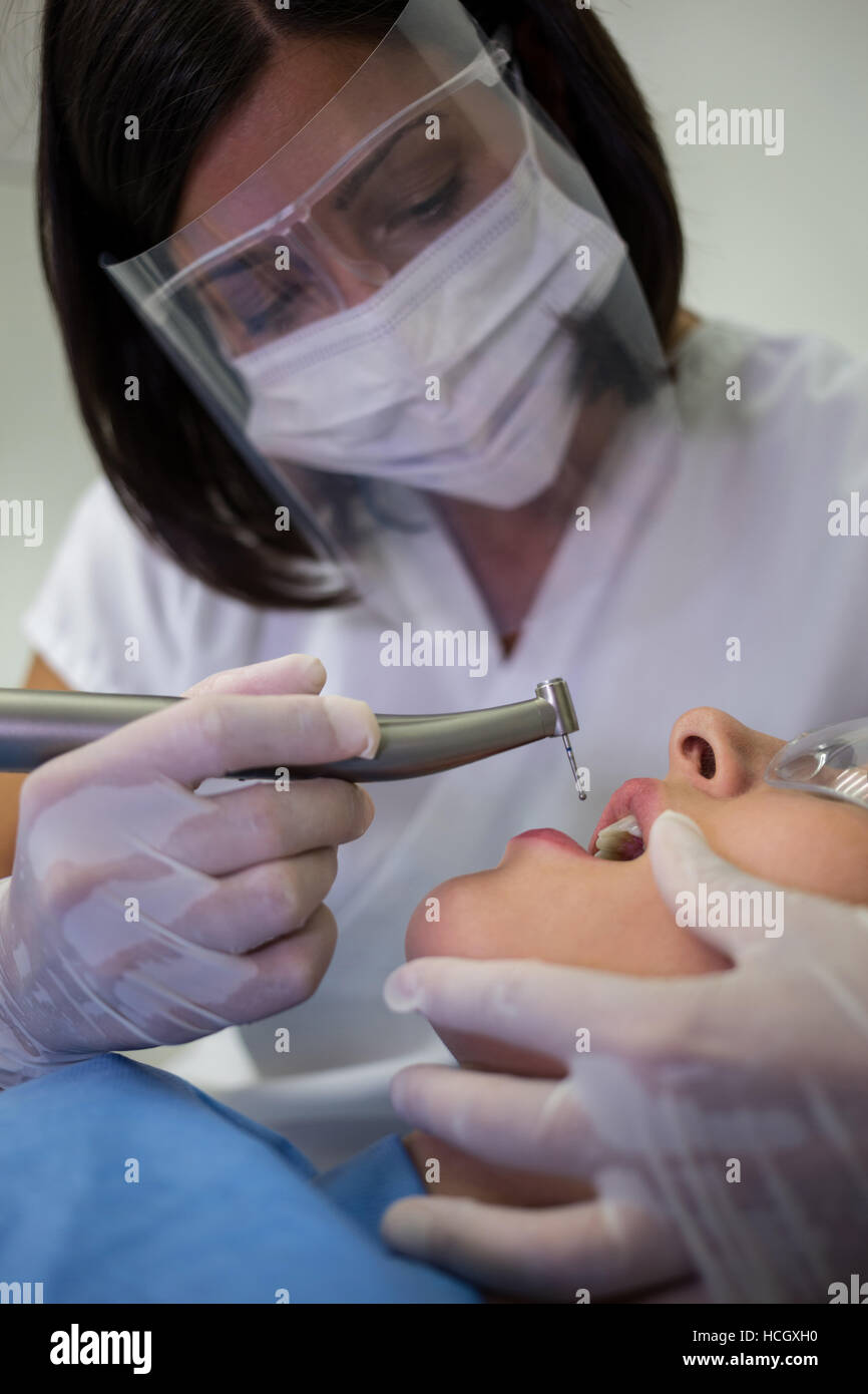 Dentist examining patients with dentistry tool Stock Photo
