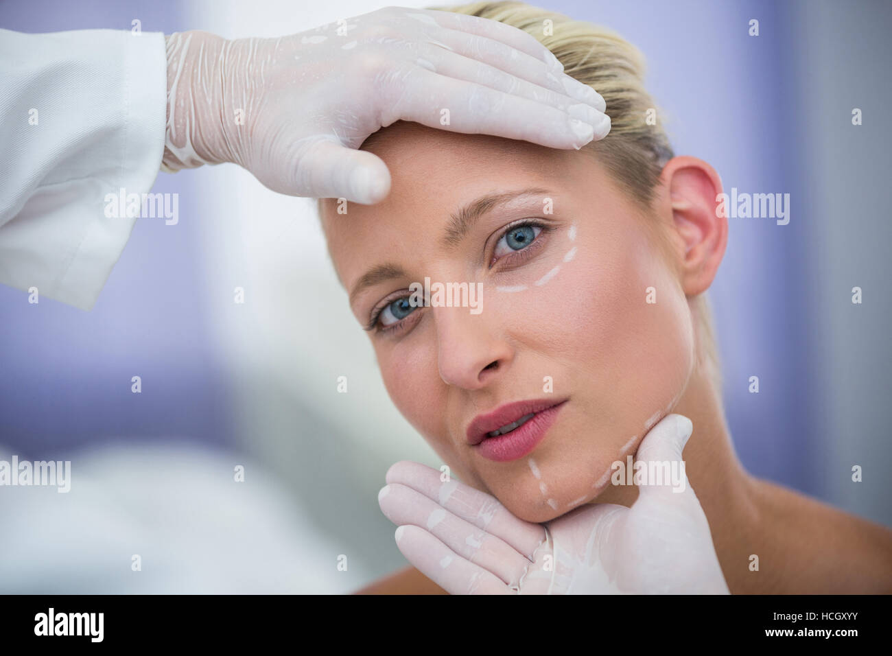 Doctor examining female patients face for cosmetic treatment Stock Photo